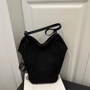 Minimalist black faux suede bucket tote bag with ring detail and shoulder strap