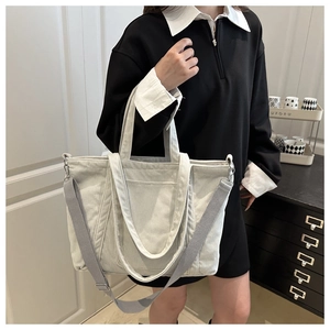 Detail of grey corduroy tote bag showing soft ribbed texture and versatile straps