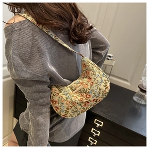 Detail view of floral jacquard hobo bag showing the intricate vintage pattern and metal buckle