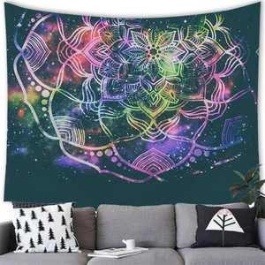 Space Mandala tapestry with colorful nebula patterns hanging above a modern living room sofa
