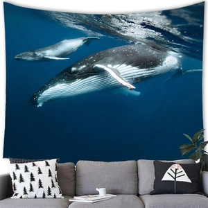 Macro detail of whale wall tapestry fabric texture hung over a gray sofa