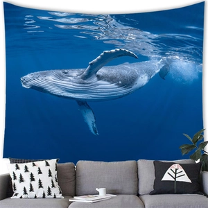Detail of whale tapestry showing fine texture and ripples on a gray wall above a sofa
