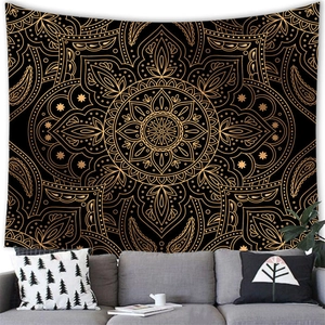 Detailed view of bohemian black and gold mandala tapestry above a modern living room sofa