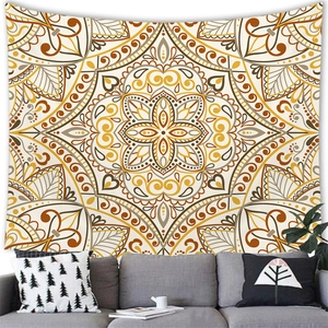 Detail of bohemian mandala tapestry featuring yellow geometric patterns above a grey sofa