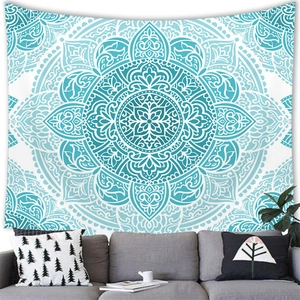 Detail of teal mandala geometric tapestry hanging as a wall backdrop above a sofa