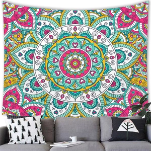 Bohemian mandala wall tapestry with colorful geometric floral patterns above a gray sofa