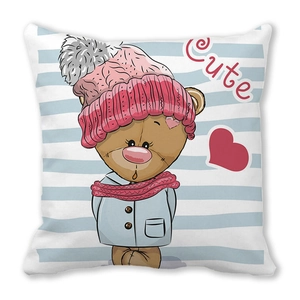 Detail of square cushion showing a cute cartoon bear in a pink hat and blue winter coat