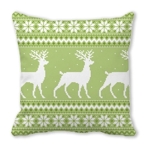Detail of pixel art reindeer and snowflake pattern on green holiday pillow case