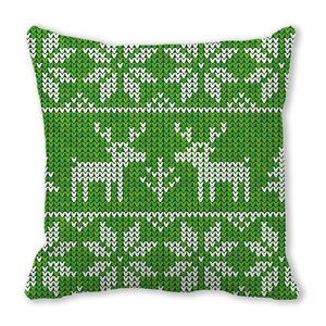 Close-up of Christmas pillow with green Nordic elk and snowflake knit pattern texture