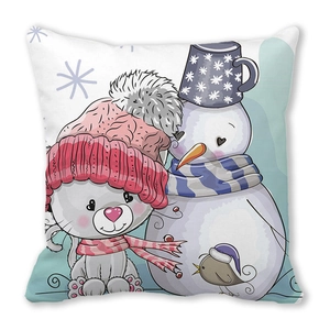 Close-up of peach skin cushion with cute cartoon cat, snowman, and winter bird design