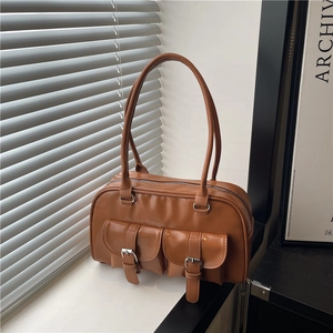 Vintage brown leather Boston bag with dual front buckle pockets and long handles