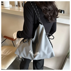 Close-up of grey large tote bag featuring thick rope handles and Fashion typography detail