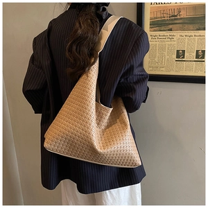 Detailed view of the woven hobo shoulder bag texture and casual crossbody style