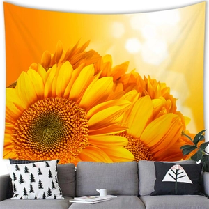 Detail of vibrant watercolor sunflower tapestry hanging above a sofa in a modern living room