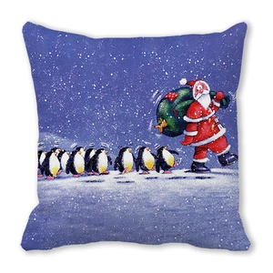 Detail of Christmas pillowcase with Santa Claus and penguins on starry blue fabric