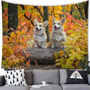 Close-up of cozy living room decor featuring two Corgis on a tapestry with autumn forest