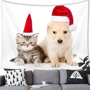 Detail of a tapestry with a puppy and kitten in Santa hats on a white living room wall