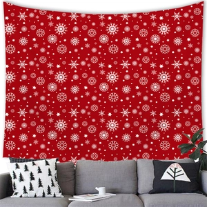 Detail of red Christmas tapestry with white snowflake patterns hanging over a sofa