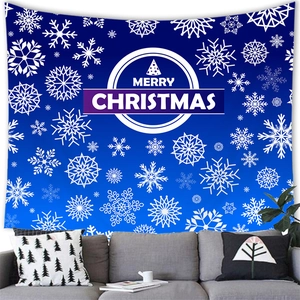 Detail of blue Christmas tapestry featuring white snowflakes behind a grey sofa