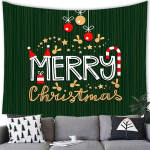 Detail of Merry Christmas tapestry showing fabric texture above a sofa in a cozy room