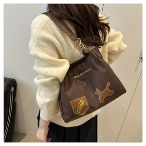 Dettaglio della borsa tote marrone scuro con stampa Tidal Dryness e patch a cucciolo