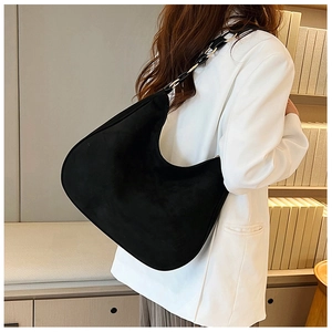 Detail of minimalist black hobo bag with a suede-like finish and mixed chain strap