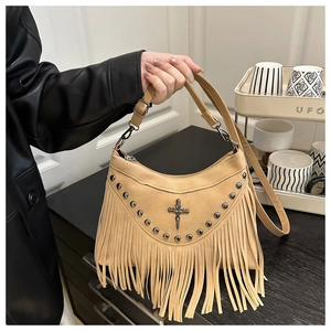 Detail of khaki tassel shoulder bag with metallic studs and cross pendant