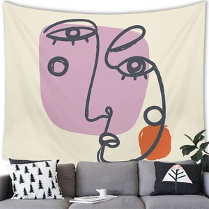 Detailed view of minimalist line art tapestry with pink and orange abstract face patterns