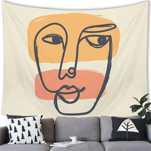 Minimalist abstract face line art tapestry on white wall over gray sofa