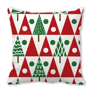 Detail of red and green geometric Christmas tree pattern on soft peach skin pillowcase