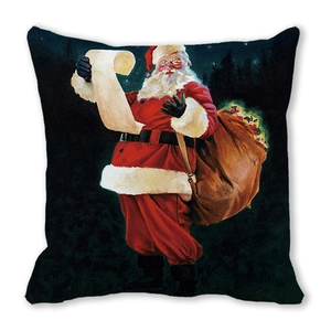 Detail of square Christmas pillow featuring Santa Claus with a gift sack on black background