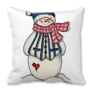 Detail of Christmas snowman pillow cover featuring blue hat and red plaid scarf