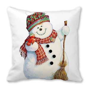 Close-up of decorative Christmas pillow featuring a hand-drawn snowman with festive details