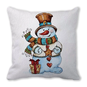 Detailed view of watercolor snowman illustration and red gift box on peach skin pillow