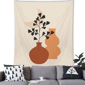 Detail of Nordic Morandi tapestry with bohemian botanical art above a grey sofa