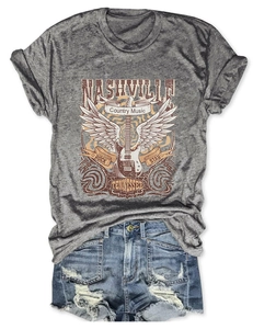 Flat lay of Nashville country music t-shirt with vintage print and distressed denim shorts