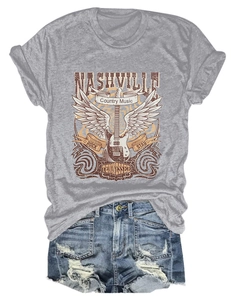 Flat lay of gray Nashville country music t-shirt with distressed denim shorts detail