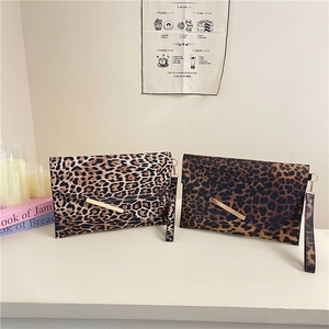 Fashionable leopard print envelope shoulder bag with gold metal trim and wrist strap