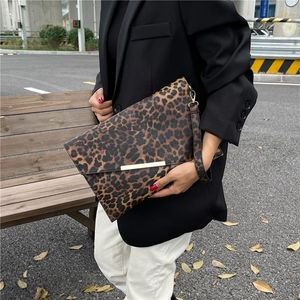 Leopard print crossbody envelope bag with gold metal bar and stylish wrist strap