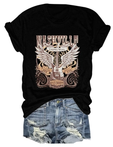 Flat lay of Nashville country music t-shirt with vintage rock guitar print and denim shorts