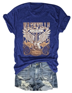 Flat lay of Nashville country music T-shirt with vintage guitar and ripped denim shorts