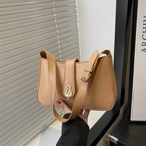 Chic camel underarm bag with a unique golden gourd buckle and adjustable strap
