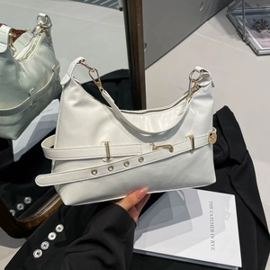 Minimalist white leather underarm bag with gold hardware and decorative grommet straps