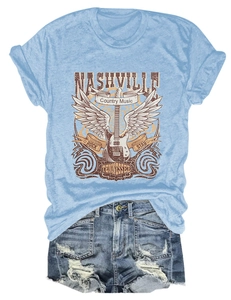 Flat lay of light blue Nashville country music t-shirt with distressed denim shorts