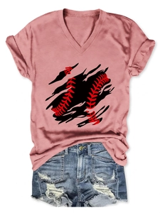 Flat lay of pink V-neck baseball print T-shirt paired with light blue distressed denim shorts