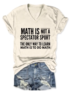 Flat lay of beige V-neck T-shirt with math text and distressed blue denim shorts