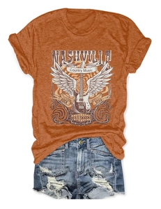 Flat lay of Nashville country music t-shirt with distressed denim shorts on white background