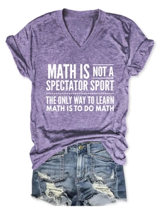 Flat lay of purple V-neck T-shirt with white math slogan and denim shorts on textured floor