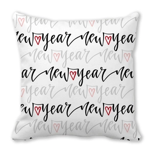 Détail du coussin de Noël en peau de pêche avec texte New Year répété et motifs de cœurs