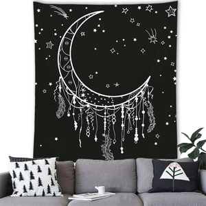 Detail of bohemian dreamcatcher tapestry with moon and feathers over a sofa